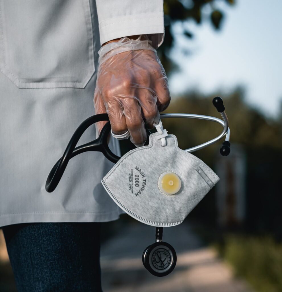 Picture of Doctor holding stethoscope and N95 mask
