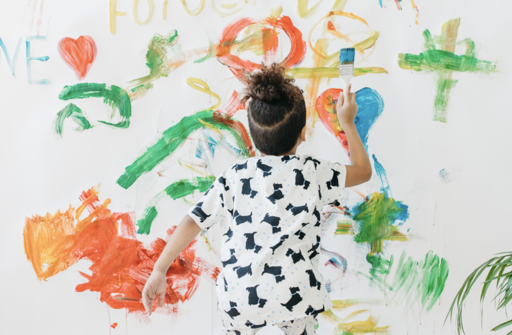 Child painting on a wall