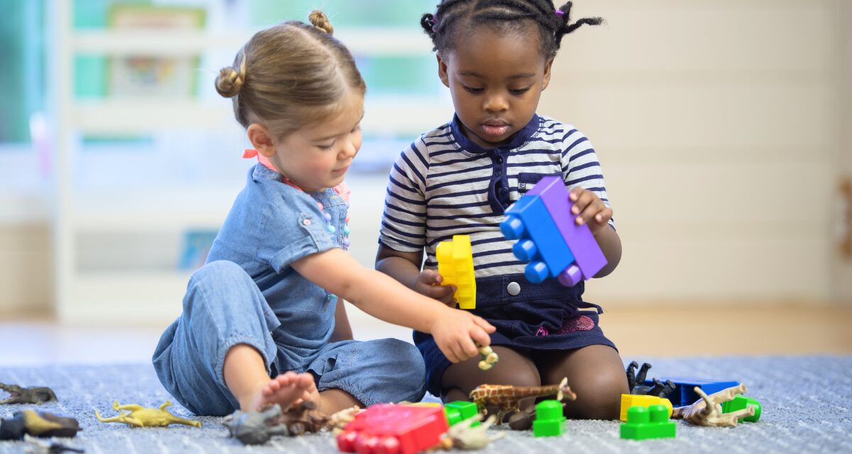 two toddlers playing with toys